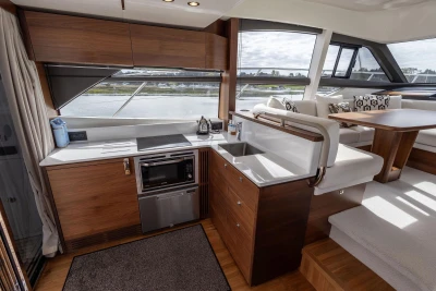 Luxurious interior of 2018 Princess 49 yacht with modern kitchen and seating area.
