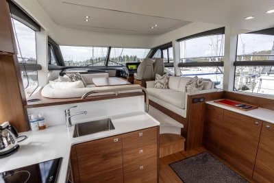Luxurious interior of a 2018 Princess 49 yacht with modern kitchen and seating area.