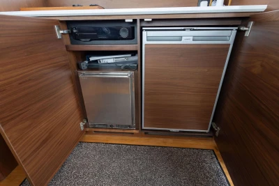 Wooden cabinet with integrated appliances in a 2018 Princess 49 yacht.
