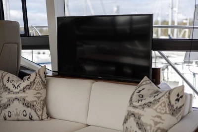 Luxurious interior of 2018 Princess 49 yacht with TV and patterned cushions.