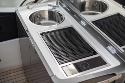 Outdoor kitchen on a 2018 Princess 49 yacht with sink and grill.