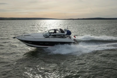 2013 Princess V39 yacht cruising on open water at sunset.