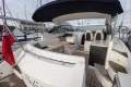 2013 Princess V39 yacht with spacious deck, seating, and canopy in marina setting.