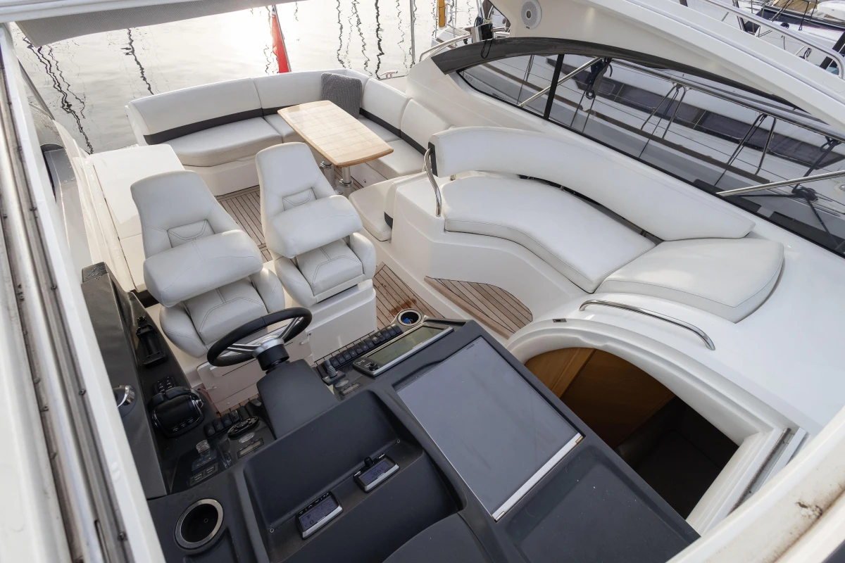Luxurious 2013 Princess V39 yacht interior with plush seating and modern helm.