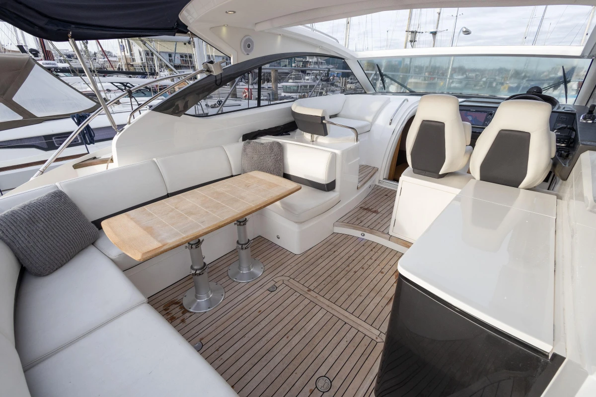 Luxurious 2013 Princess V39 yacht interior with elegant seating and wooden flooring.
