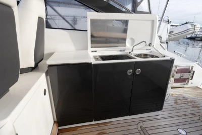 Outdoor kitchenette on 2013 Princess V39 yacht with sink and stove.