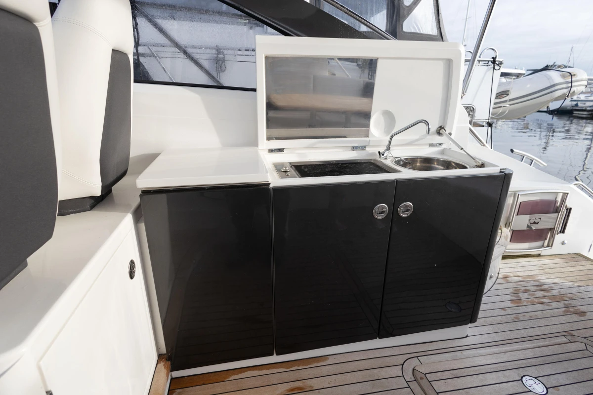 Outdoor kitchenette on 2013 Princess V39 yacht with sink and stove.