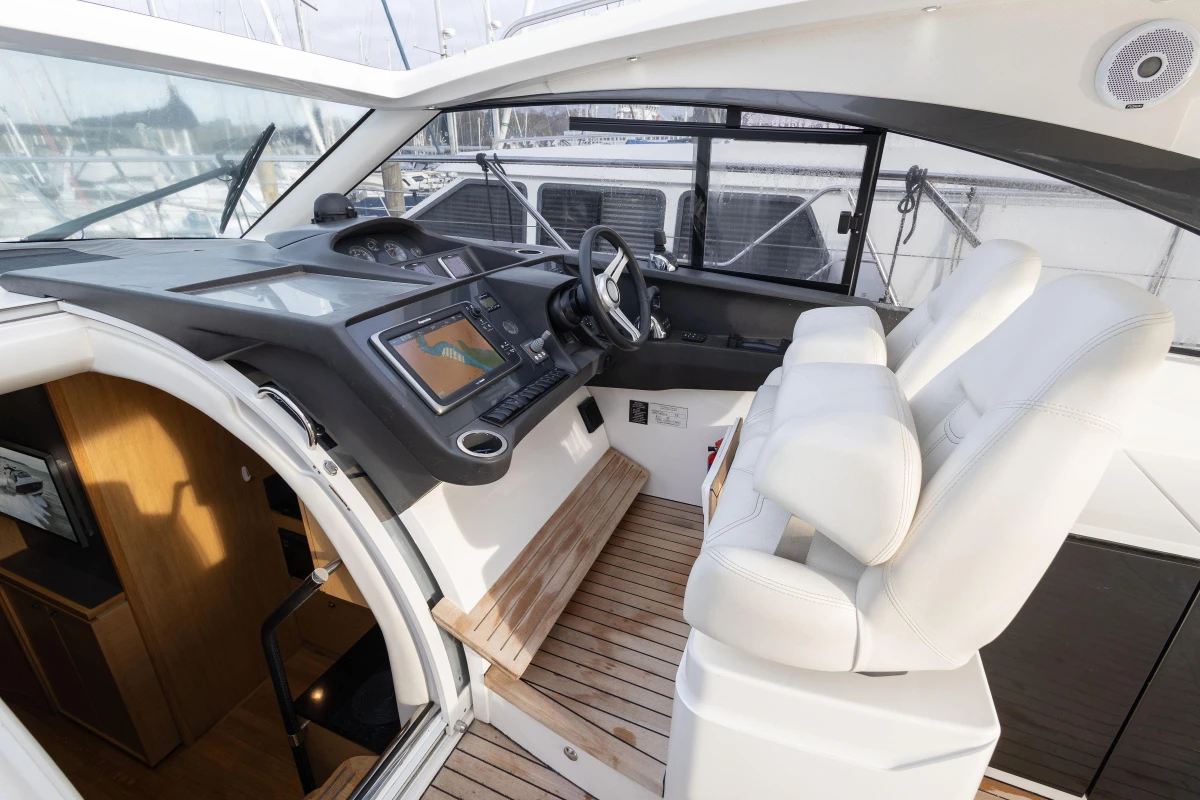 2013 Princess V39 yacht cockpit with modern controls and white seating.