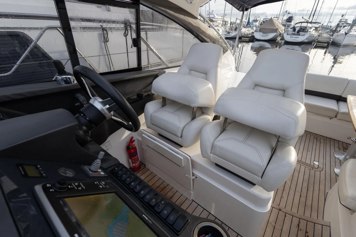 Interior of 2013 Princess V39 yacht with luxurious seating and navigation controls.