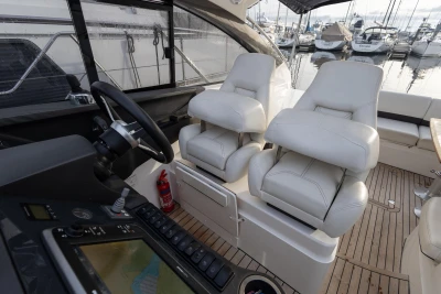 Interior of 2013 Princess V39 yacht with luxurious seating and navigation controls.