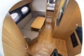 Interior of 2013 Princess V39 yacht with cozy seating and wooden finishes.