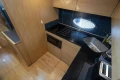Compact kitchen in 2013 Princess V39 yacht with modern appliances and sleek design.