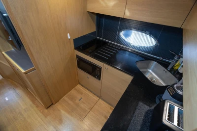 Compact kitchen in 2013 Princess V39 yacht with modern appliances and sleek design.