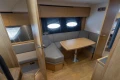 Interior of 2013 Princess V39 yacht with cozy seating and wooden table.