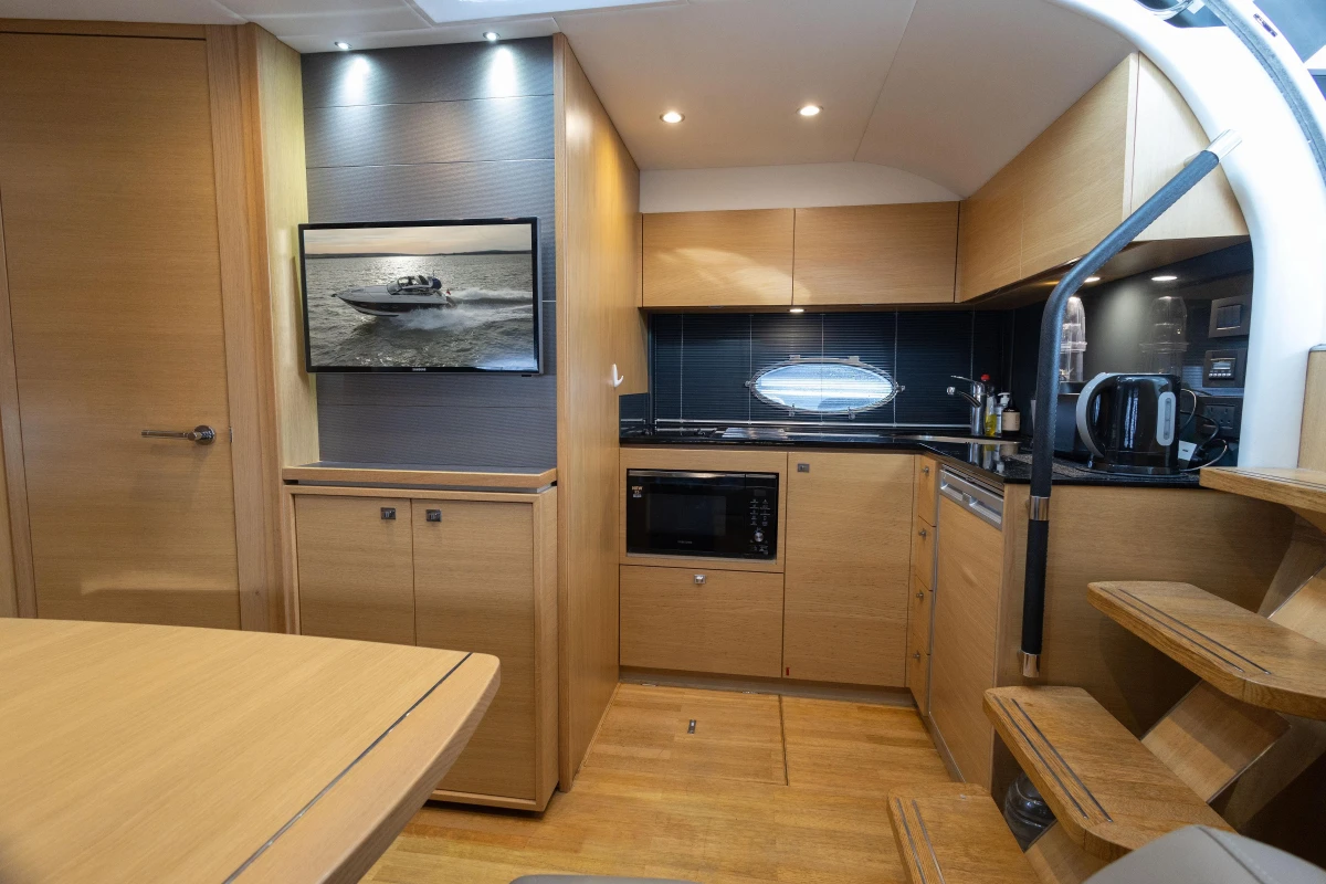 Luxurious 2013 Princess V39 yacht interior with modern kitchen and wooden cabinetry.