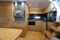 Luxurious 2013 Princess V39 yacht interior with modern kitchen and wooden cabinetry.