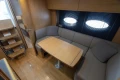 Luxurious 2013 Princess V39 yacht interior with cozy seating and elegant wooden table.