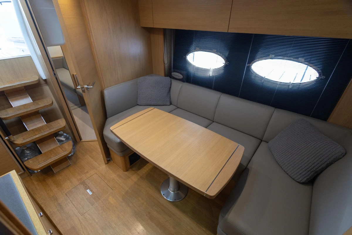 Luxurious 2013 Princess V39 yacht interior with cozy seating and elegant wooden table.