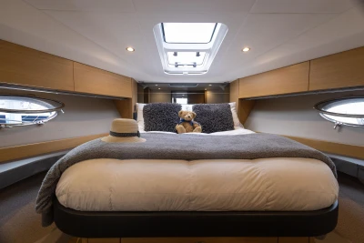 Luxurious 2013 Princess V39 yacht cabin with plush bedding and elegant decor.