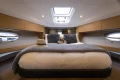Luxurious 2013 Princess V39 yacht cabin with plush bedding and elegant decor.