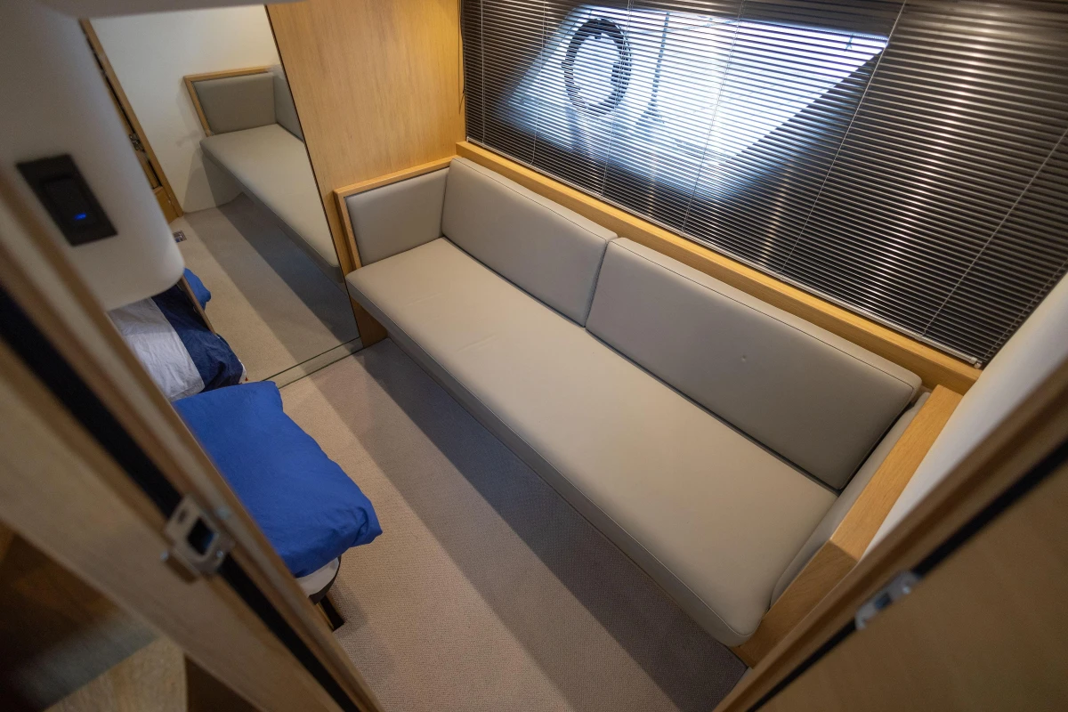 Interior of 2013 Princess V39 yacht with beige sofa and modern design.