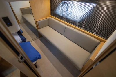 Interior of 2013 Princess V39 yacht with beige sofa and modern design.