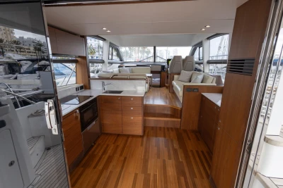 Luxurious interior of 2017 Princess 49 yacht with modern kitchen and seating area.