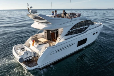 Luxurious 2017 Princess 49 yacht cruising on open water, featuring sleek design and spacious deck.