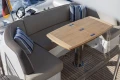 Luxurious seating area on 2017 Princess 49 yacht with wooden table and striped cushions.