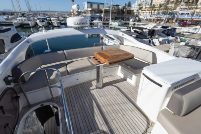 Luxurious 2017 Princess 49 yacht deck with seating and table in marina.