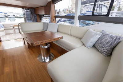 Luxurious interior of 2017 Princess 49 yacht with elegant seating and wooden table.