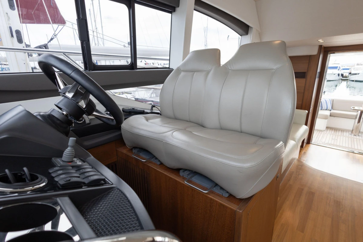 Interior of 2017 Princess 49 yacht with leather seating and steering wheel.