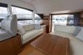 Luxurious interior of 2017 Princess 49 yacht with elegant seating and marina view.