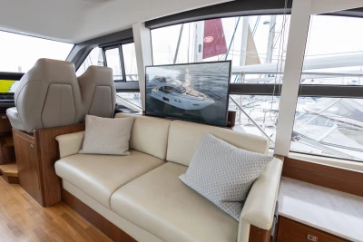 Luxurious interior of 2017 Princess 49 yacht with comfortable seating and large windows.