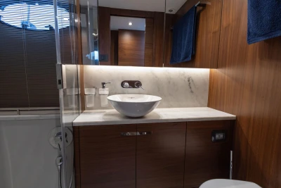 Luxurious bathroom in 2017 Princess 49 yacht with modern sink and wooden cabinetry.
