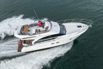 2016 Princess 43 yacht cruising on open water, aerial view.