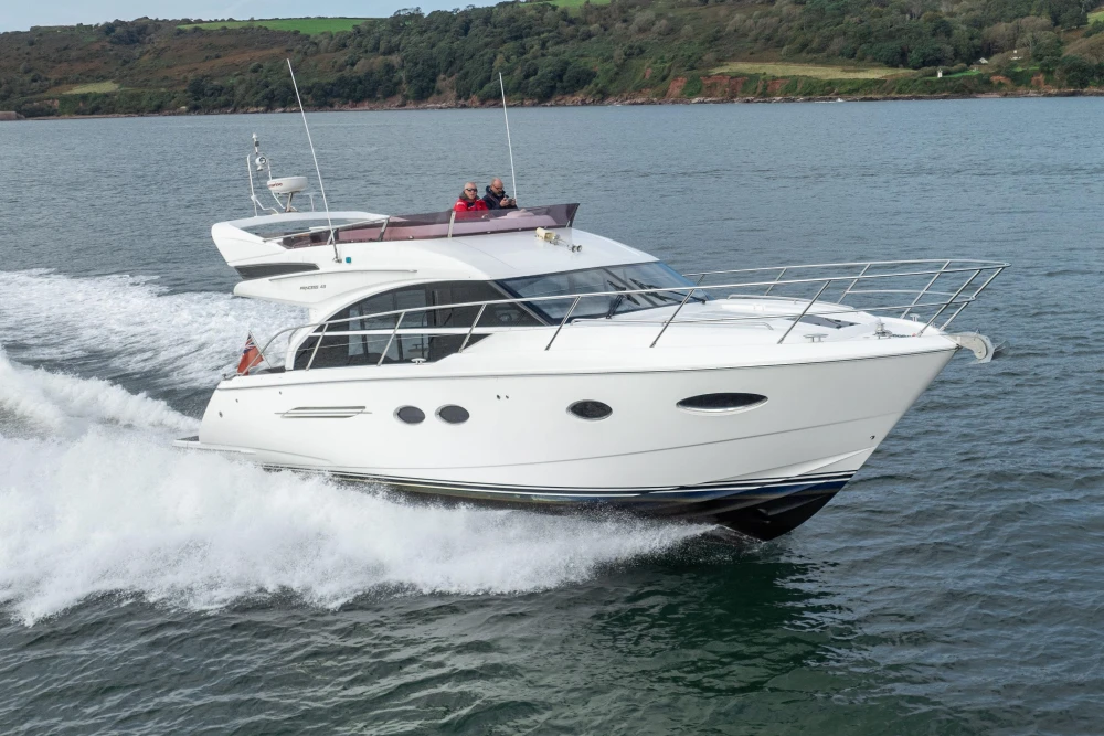 2016 Princess 43 yacht cruising on open water, showcasing sleek design and performance.