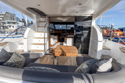 Luxurious 2016 Princess 43 yacht interior with seating, table, and marina view.
