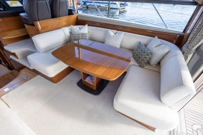 Luxurious interior of 2016 Princess 43 yacht with elegant seating and wooden table.