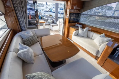 Luxurious interior of a 2016 Princess 43 yacht with elegant seating and wooden accents.