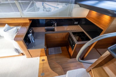 Luxurious kitchen interior of 2016 Princess 43 yacht with modern appliances and wood finish.