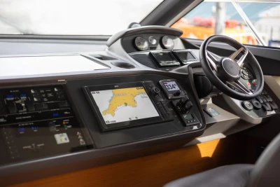Cockpit of 2016 Princess 43 yacht with navigation system and steering wheel.