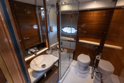Luxurious bathroom in 2016 Princess 43 yacht with modern fixtures and wooden accents.