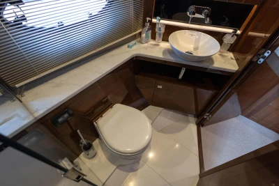 Luxurious yacht bathroom with modern fixtures, featuring a sink and toilet. Princess 43, 2016 model.