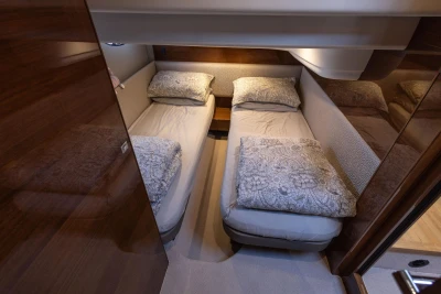 Luxurious twin cabin in 2016 Princess 43 yacht with elegant bedding.