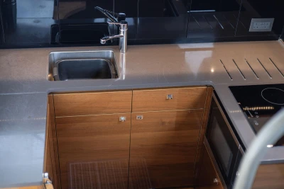 Modern kitchen area in a 2016 Princess 43 yacht with sleek cabinetry and stainless steel sink.