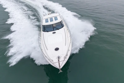 2009 Princess V58 yacht cruising swiftly on open water.