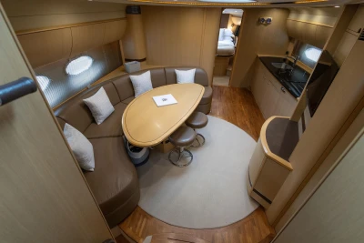 Luxurious interior of 2009 Princess V58 yacht with elegant seating and modern kitchen.