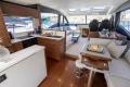 Luxurious interior of 2022 Princess S66 yacht with modern kitchen and seating area.
