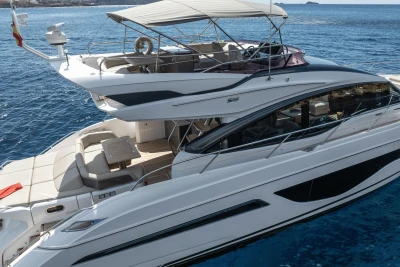 Luxury 2022 Princess S66 yacht on blue ocean, featuring sleek design and spacious deck.